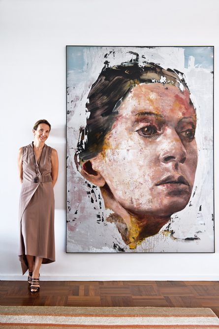 Interior designer and homeowner Laurence Beysecker stands beside Portrait of any woman saint after having cried by Mateo Sbaragli.
