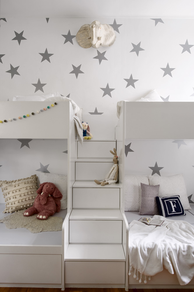 Starry wallpaper endows the children's bedroom with a sense of adventure.