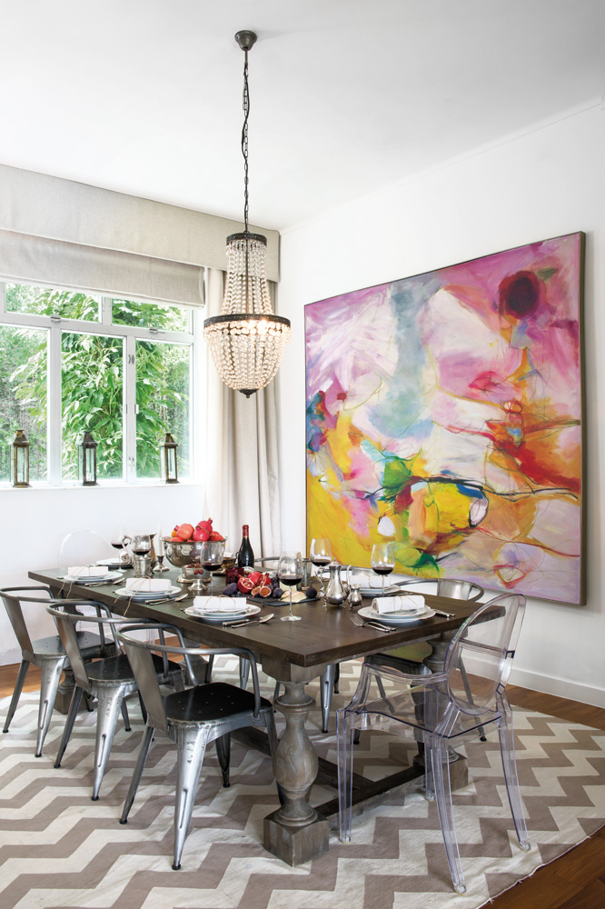 An arresting abstract bought in Dafen Art Village adds bright bursts of colour in the inviting dining area.