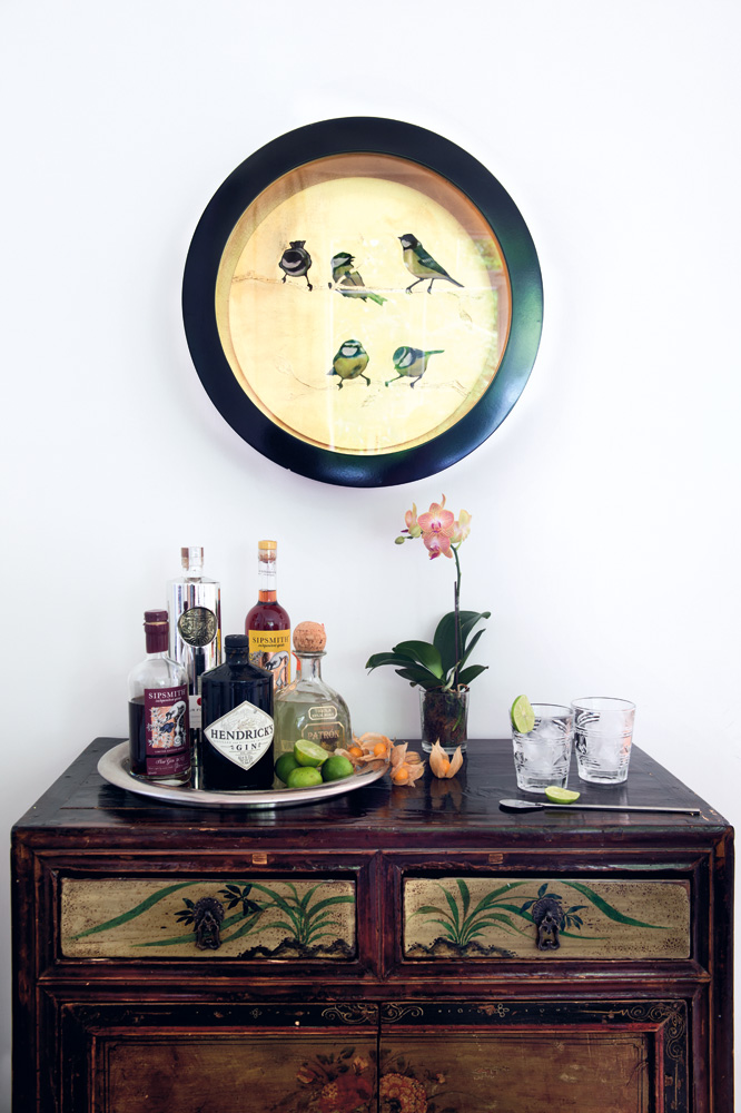 Little Birds by Sally-Ann Johns hangs above an antique cabinet purchased on Hollywood Road.