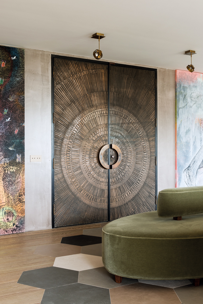 A pair of 1950s beaten-bronze doors at the entrance set the tone for the whole scheme of the flat.