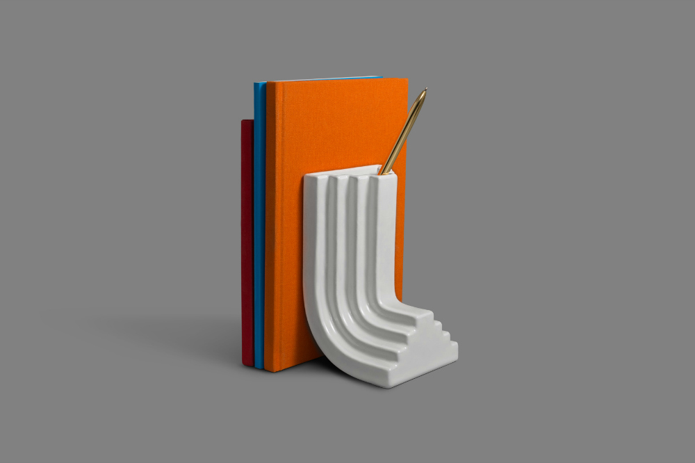 The 3D printed porcelain Carlo Bookend by Ini Archibong presents a subtle nod to architectural geometry. 
