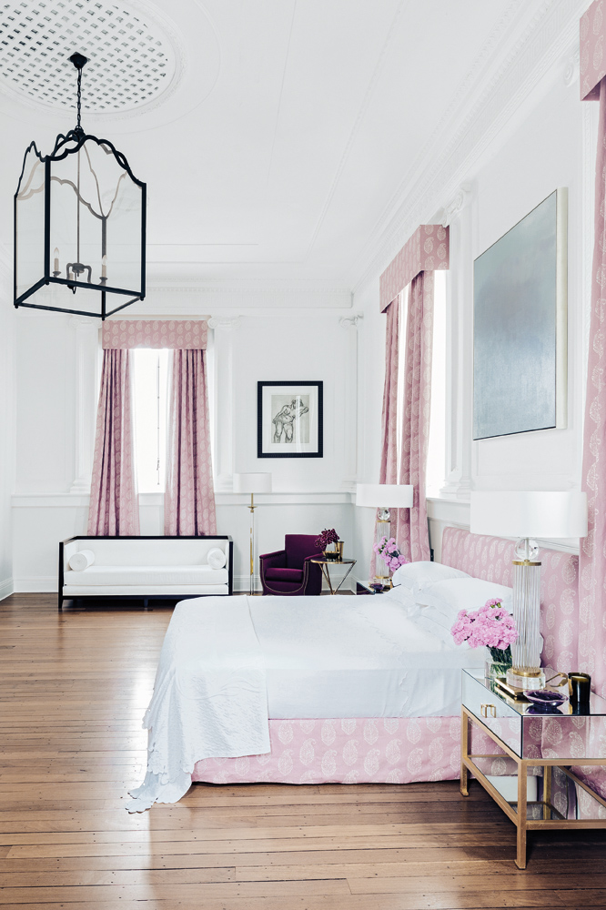 The master bedroom runs the length of the home, but the lilac linen and curtains lend it an air of intimacy.