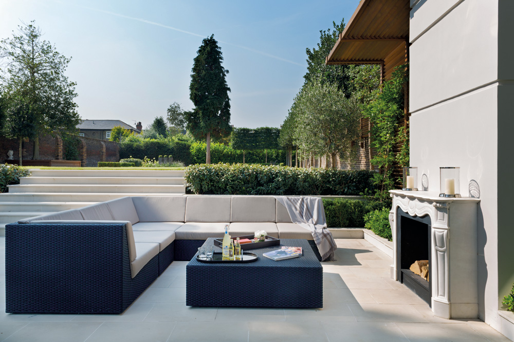 A sprawling patio with manicured gardens to the rear is perfect for entertaining.