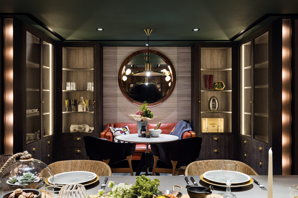 The breakfast table from Tom Dixon sits in a nook adjacent to the main dining table. The suspended light is also from Tom Dixon.