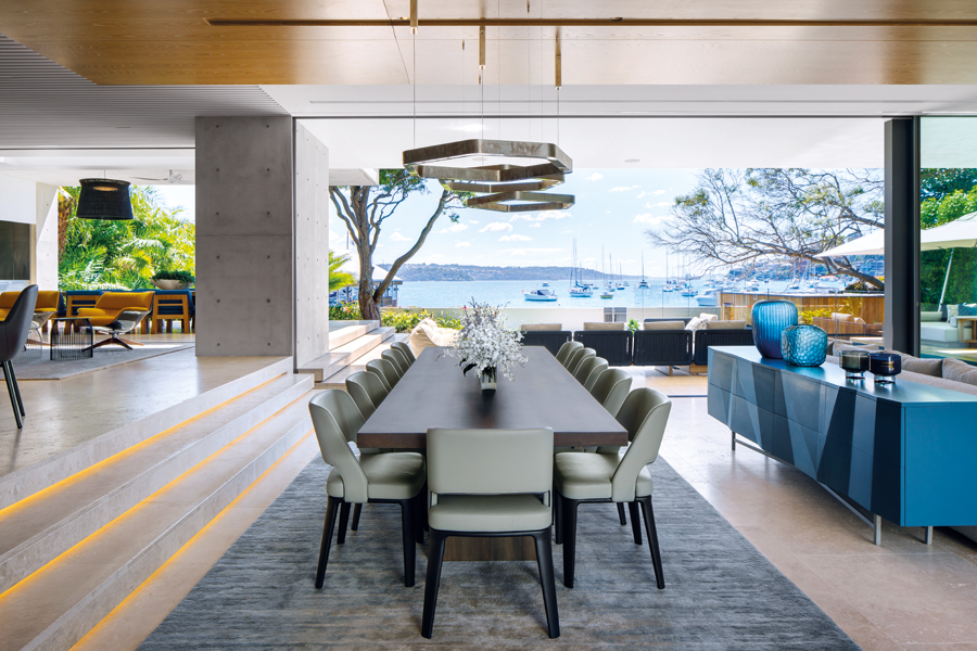 A Polygonal Ring pendant light from Henge hangs over the formal dining table, with hand-tufted rugs of wool and bamboo silk underfoot. (Photo: Adam Letch)