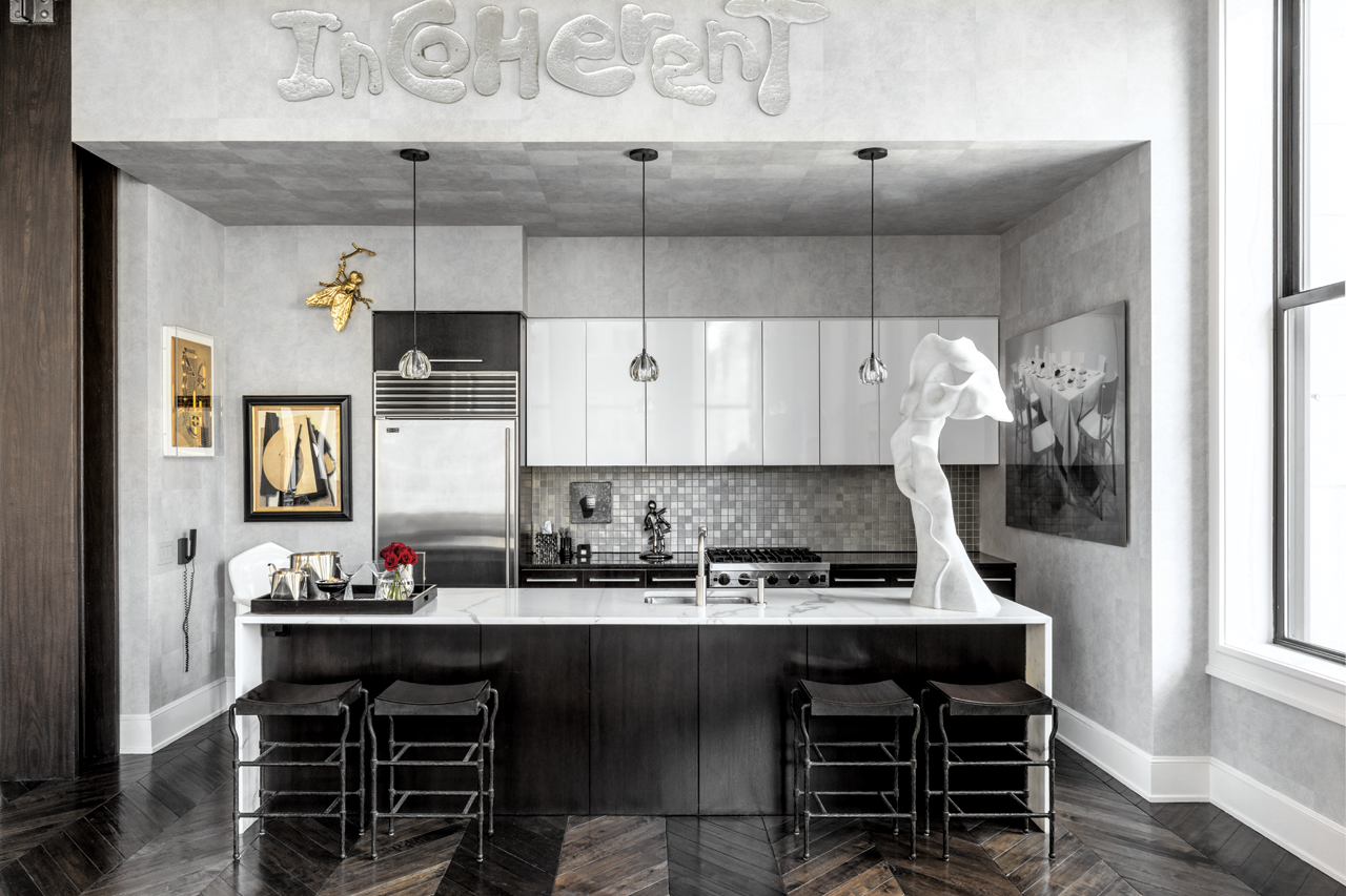 A white sculpture by Helaine Blumenfeld on the kitchen island, above is a work by Rob Wynne