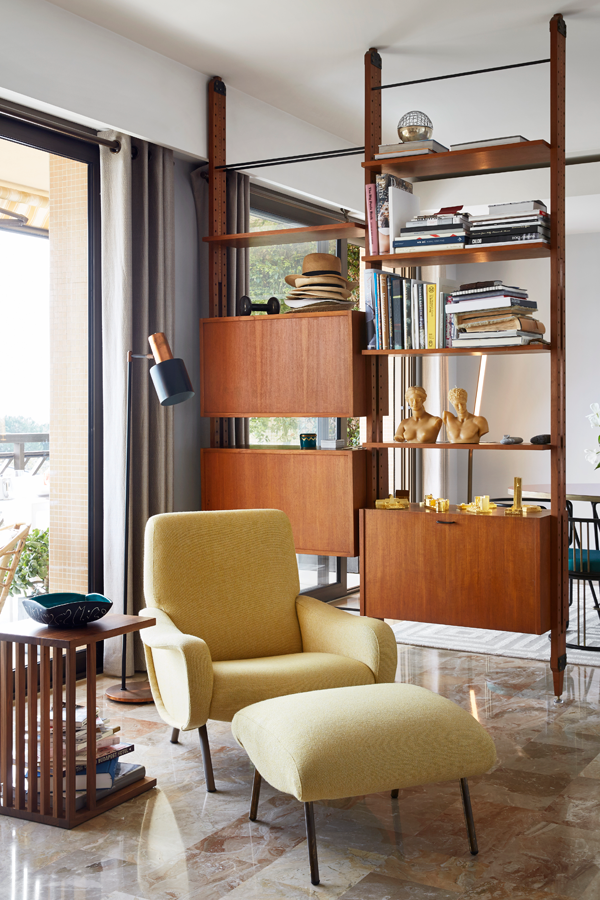 A Marco Zanusso chair and footstool add a bright pop of yellow in the room