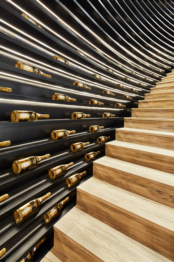 The Wine Palace at the Monaco Yacht Club showcases over 2,000 bottles through custom-built shelves in natural, black and ash oak wood paved with bronze