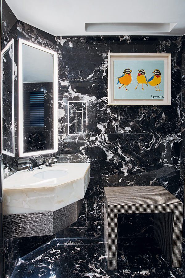 Outfitted in black striated marble, the bathroom is a private sanctuary where the couple can enjoy a holistic experience