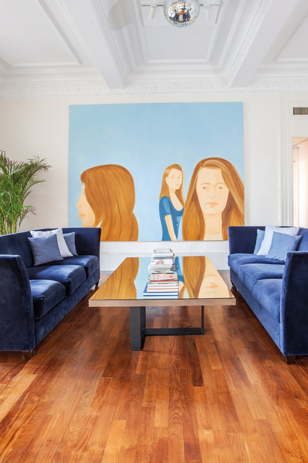 Another painting by Alex Katz, this time in the living room, reflects against the mirrored coffee table