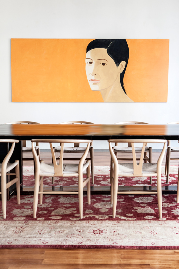 An Alex Katz piece in the dining room, along with Hans Wegner Wishbone chairs