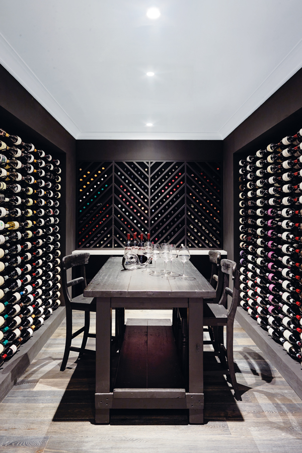 The well-stocked wine cellar is another of the home’s more surprising spaces, along with a cinema