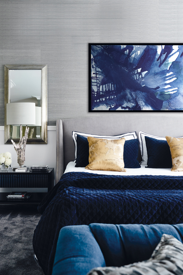 The master bedroom elevates shades of blue and grey to indulgent levels of luxury, encouraging relaxation