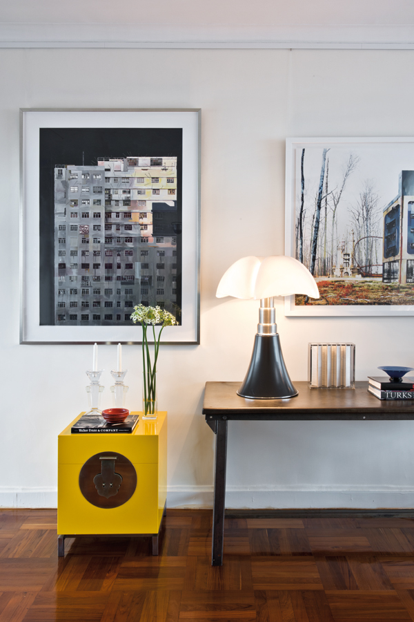 A yellow chest by David Ng is paired with a rendition of the Model Pipistrello lamp designed by Gae Aulenti