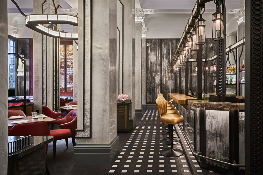 The main dining room and bar flow naturally into each other, although the bar is clearly delineated with striking checkered flooring