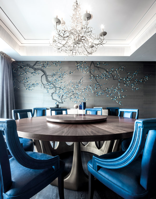 A hand-painted silk wallcovering with embroidered blossoms by Fromental sets the design direction for the dining room