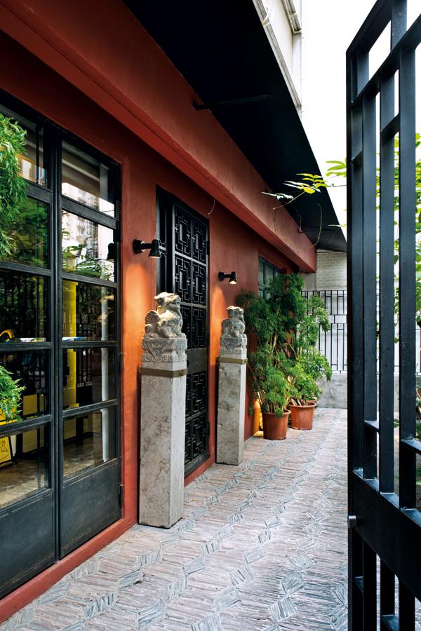 The ruby red facade and iron front gate, flanked by a pair of Chinese stone lions that were hand-picked from the Xiguan antiques market in Guangzhou, set the tone for the equally impressive interiors