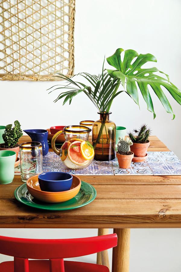 The Mexican glasses can be purchased at Strejf Fra Verden and the tinted glass vase is from House Doctor, while the tiles on the table are by Silvan