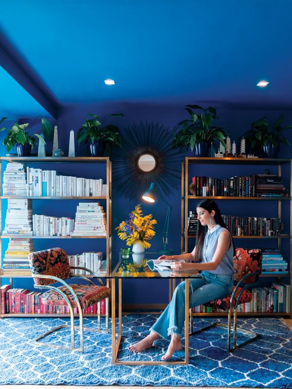 Personal stylist and decorator Lucia Tait Tolani in her home office, painted in a vivid shade of blue