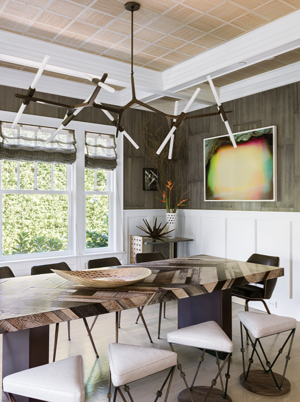 Mood lighting was very important to Nav; in the dining room, the Agnes chandelier by Lindsey Adelman is coupled with a custom-designed dining table and triangular stools. The abstract artwork is Bronson Caves #3, a C-print from 2010 by Brice Bischoff.