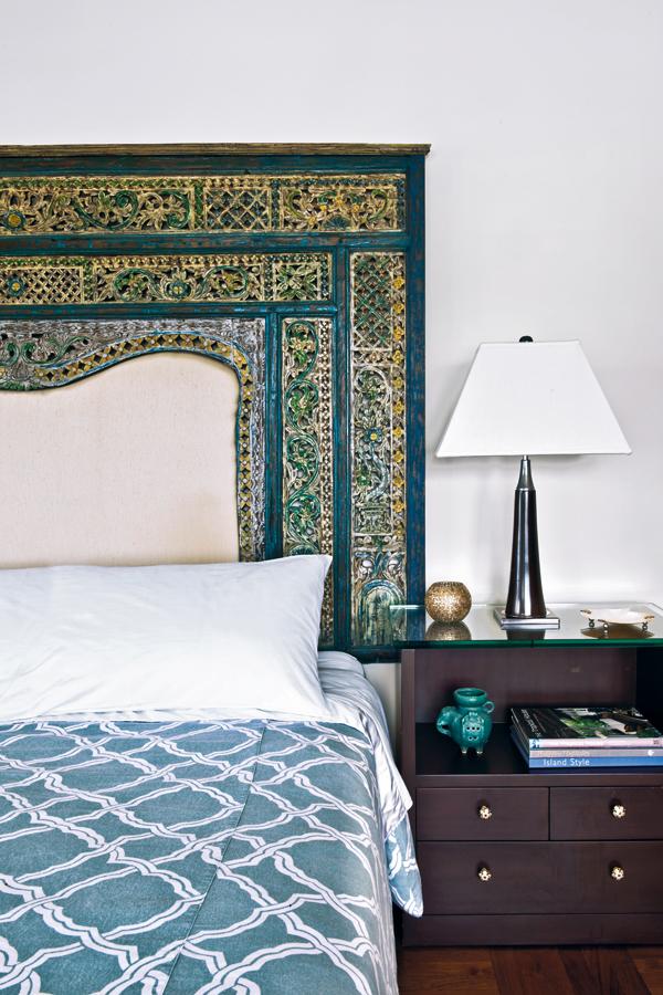 The intricately patterned headboard in the master bedroom is a Javanese doorway, bought on honeymoon in Bali.