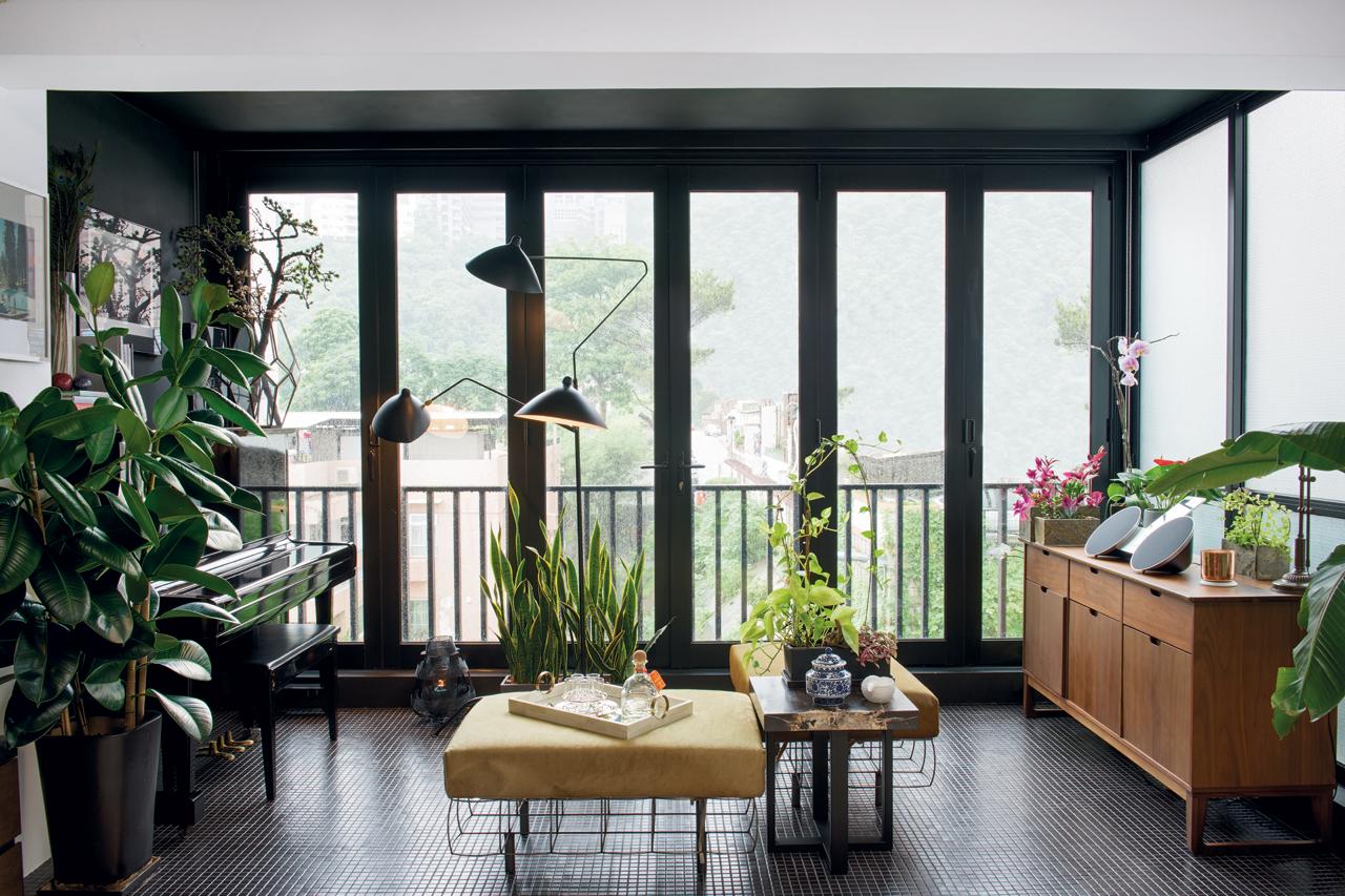 Lush green foliage spills out on the extended patio  to create a private interior garden