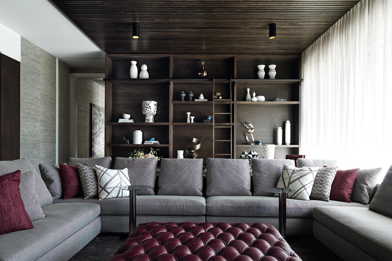 Sculptural objets d'art fill the living room's open shelving