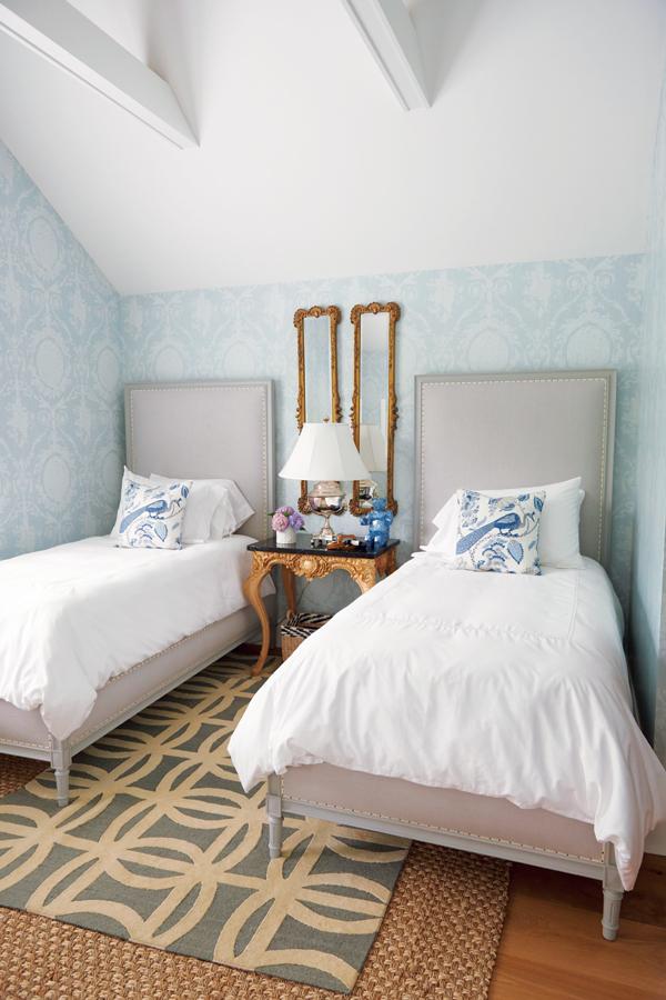 Ralph Lauren wallpaper and a vintage night table complete the French-themed guest bedroom