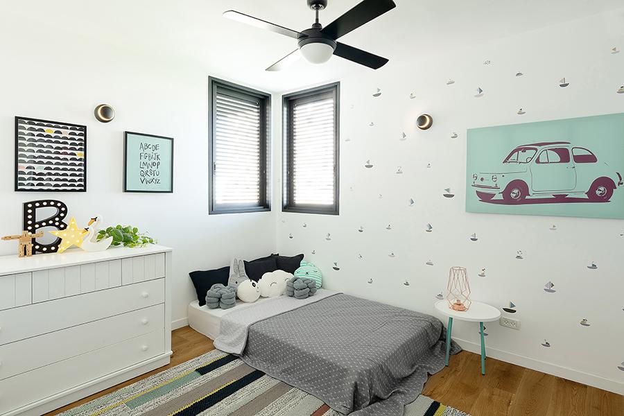Bright turquoise, white, and stripes and patterns colour the children's bedroom