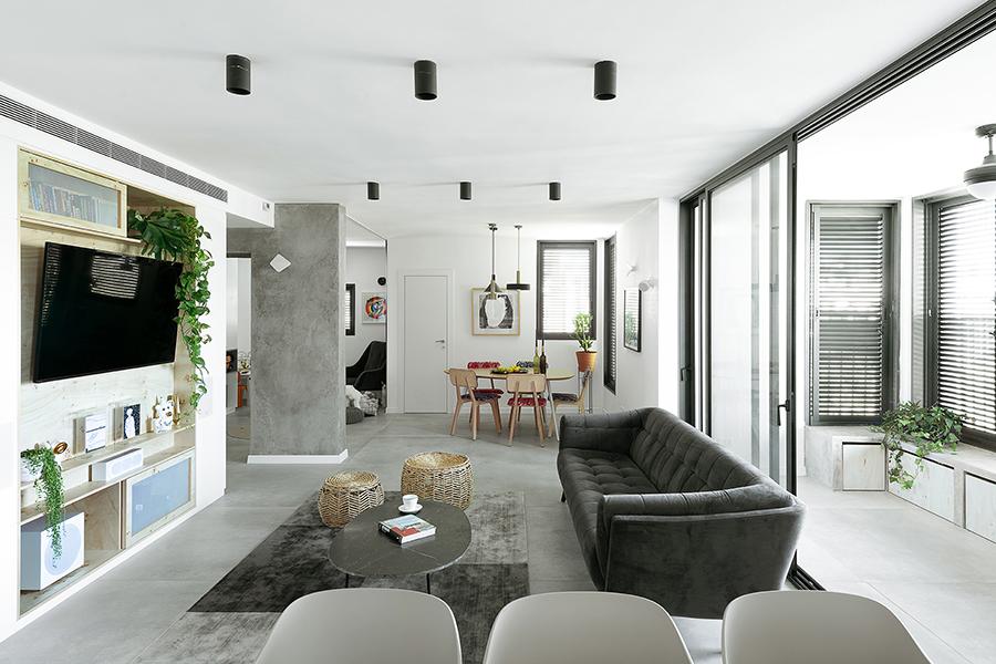 The rest of the home's open-plan public area is within view from the kitchen, from the closed balcony to the right, to the play room farther out, to the left. Next to the dining area, a small but well-ventilated room is specially created for the cats
