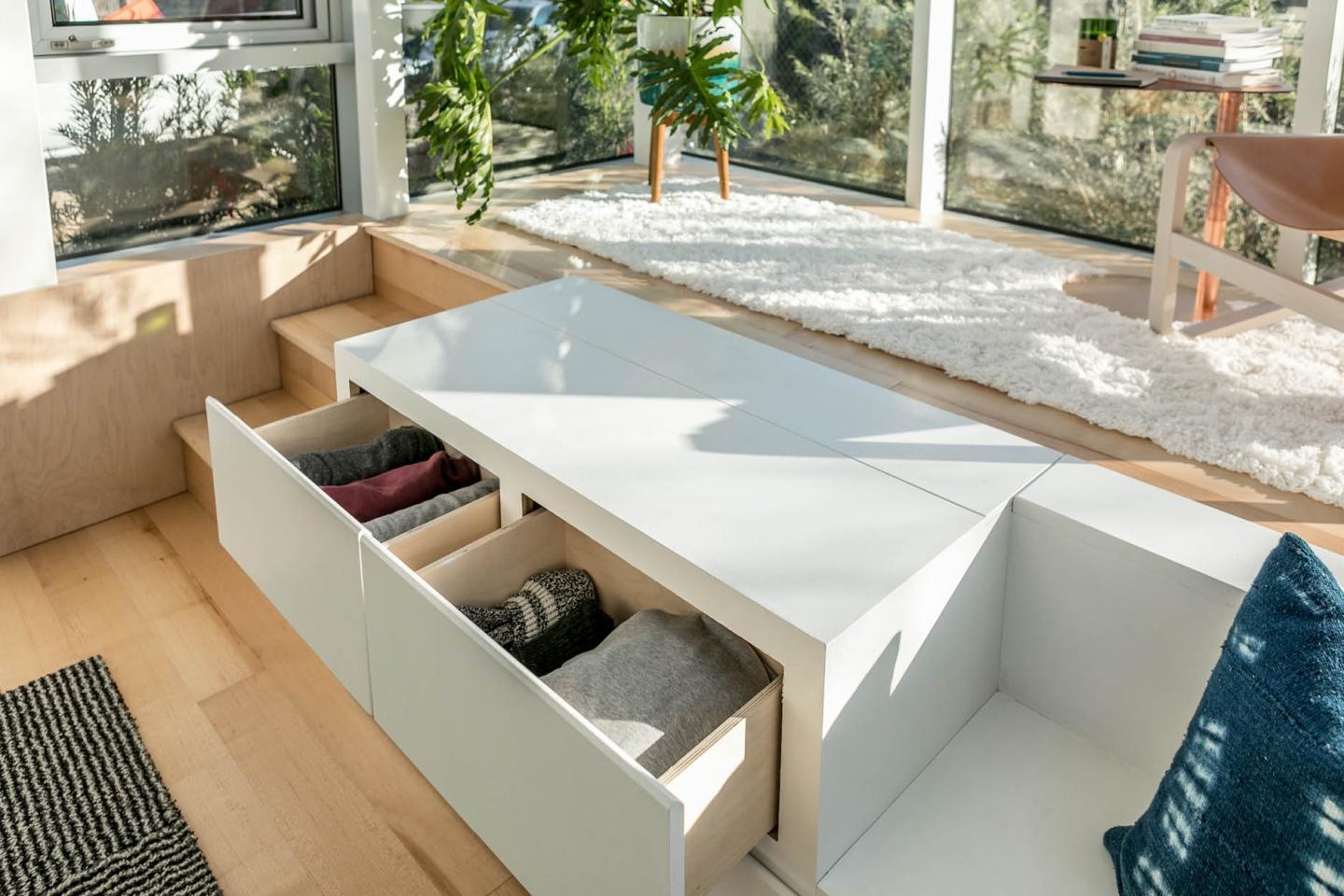 Surprising storage units are seamlessly embedded throughout the space can this particular design can double as a platform to read or enjoy a sip of coffee