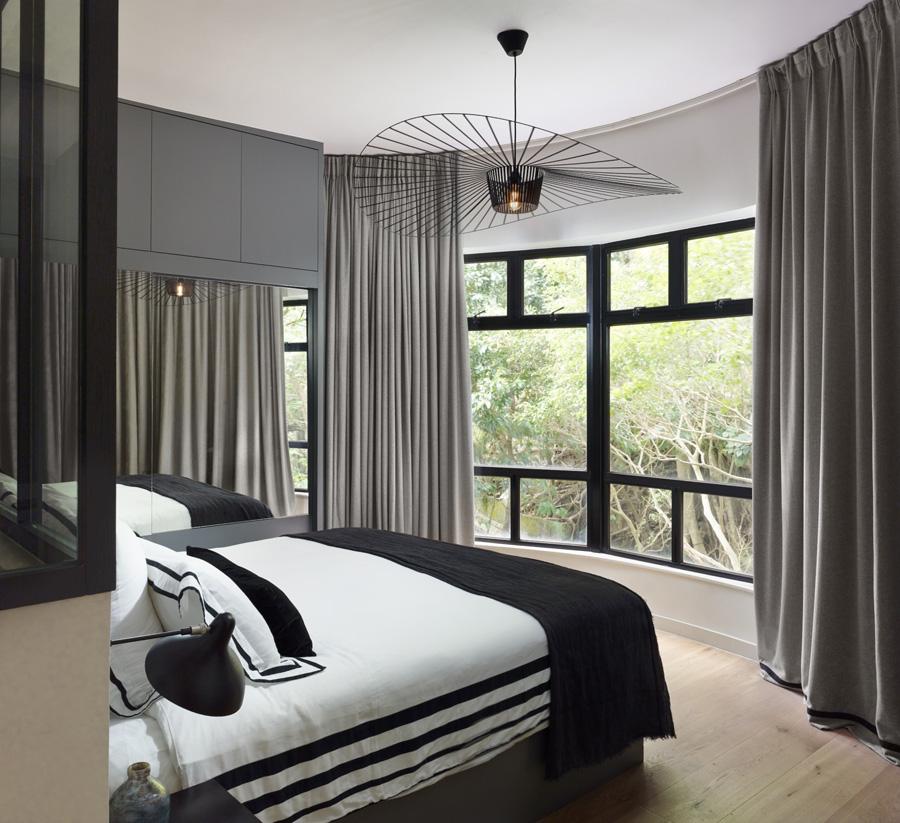 The bedroom looks out to tranquil green panoramas and feels miles removed from the hectic city