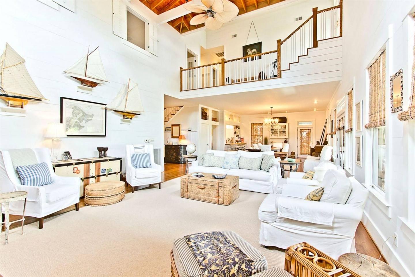 Breezy, airy aesthetics govern the home's interiors complete with wooden accents, wicker furniture and marina memorabilla 