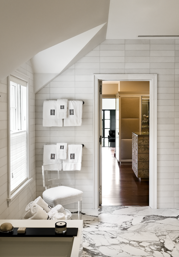 Rustic charm meets opulence in the home's bathrooms, appointed in brick and marble