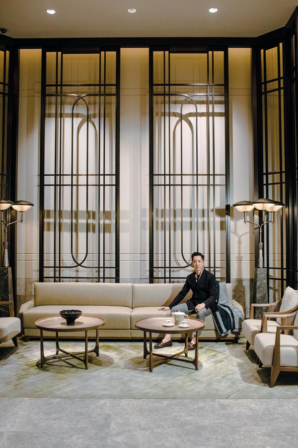 André photographed in the hotel's vestibule adorned with furnishings and lighting custom designed by AFSO; throw by André Fu Living