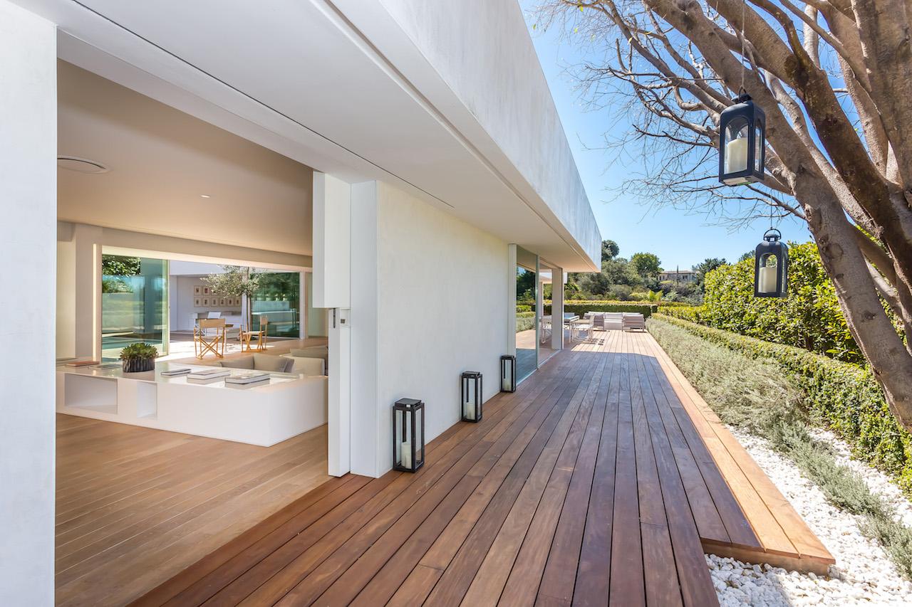 A wooden deck that wraps around the main home allows entertaining to spill over outside