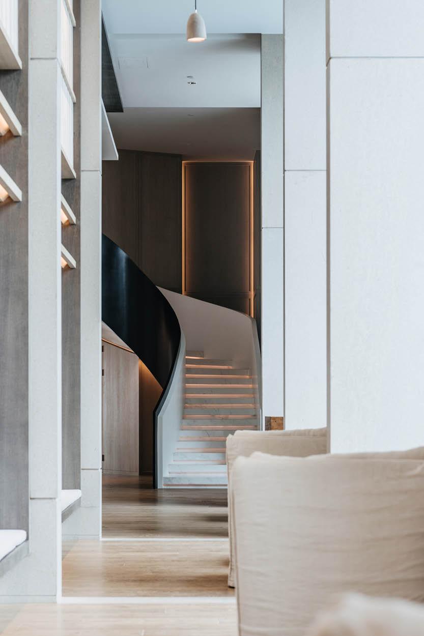 A spiral staircase inside of the penthouse