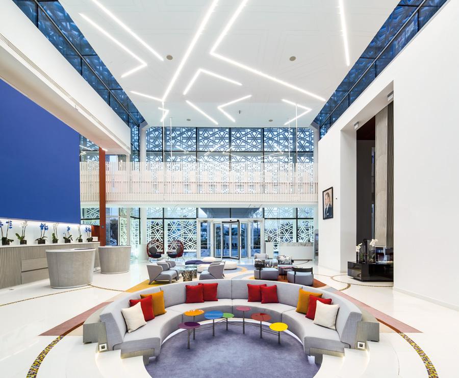 The double-height lobby boasts pops of colour, rich Moroccan blues, contemporary artworks and modern moucharaby screens