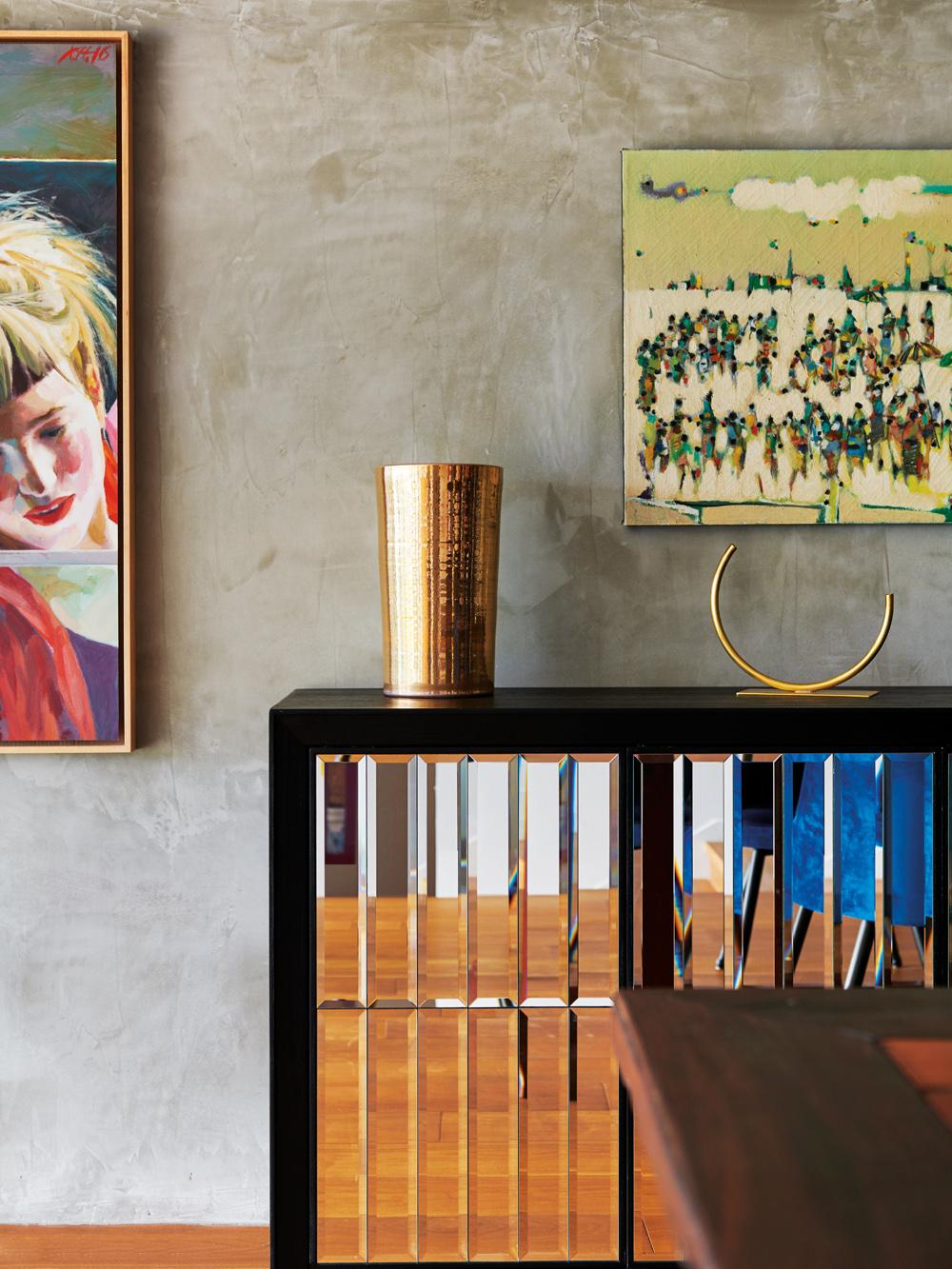 Vibrant artwork and golden accents are peppered throughout the home