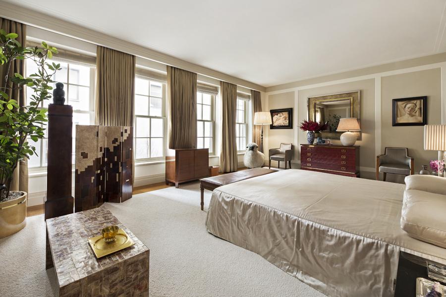 The master bedroom features retro accents such as an oriental-style screen, a dresser and mirror from Bernd Goeckler Antiques 