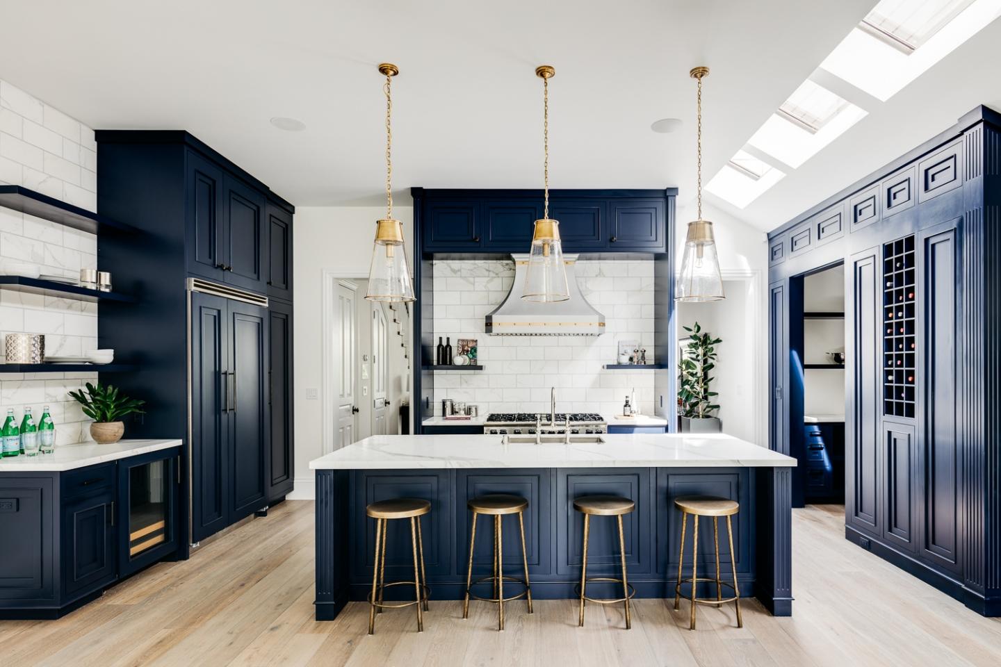 The kitchen was transformed with Calcutta Oro marble, Viking appliances, and deep blue and gold accents
