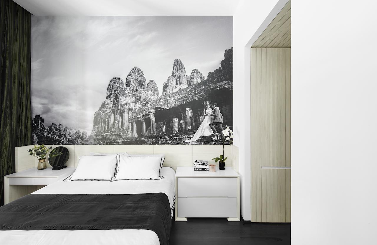 The large mural of the couple’s wedding photo underlines the voluminous ceiling in the master bedroom 