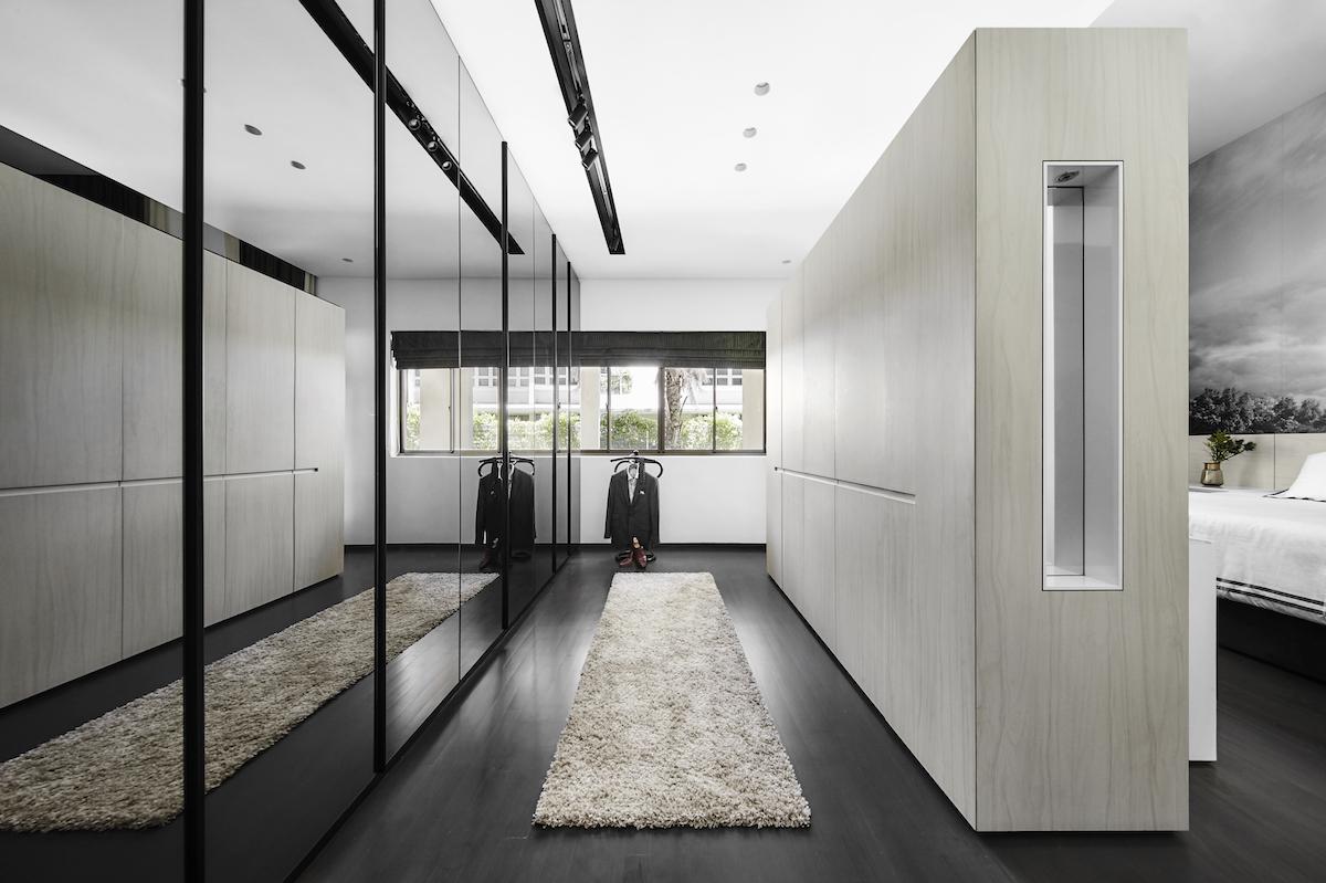The master bedroom also contains a wardrobe, designed by Puah to resemble a foyer. Black tinted mirrors are the ideal finish to cleverly camouflage the closet spaces