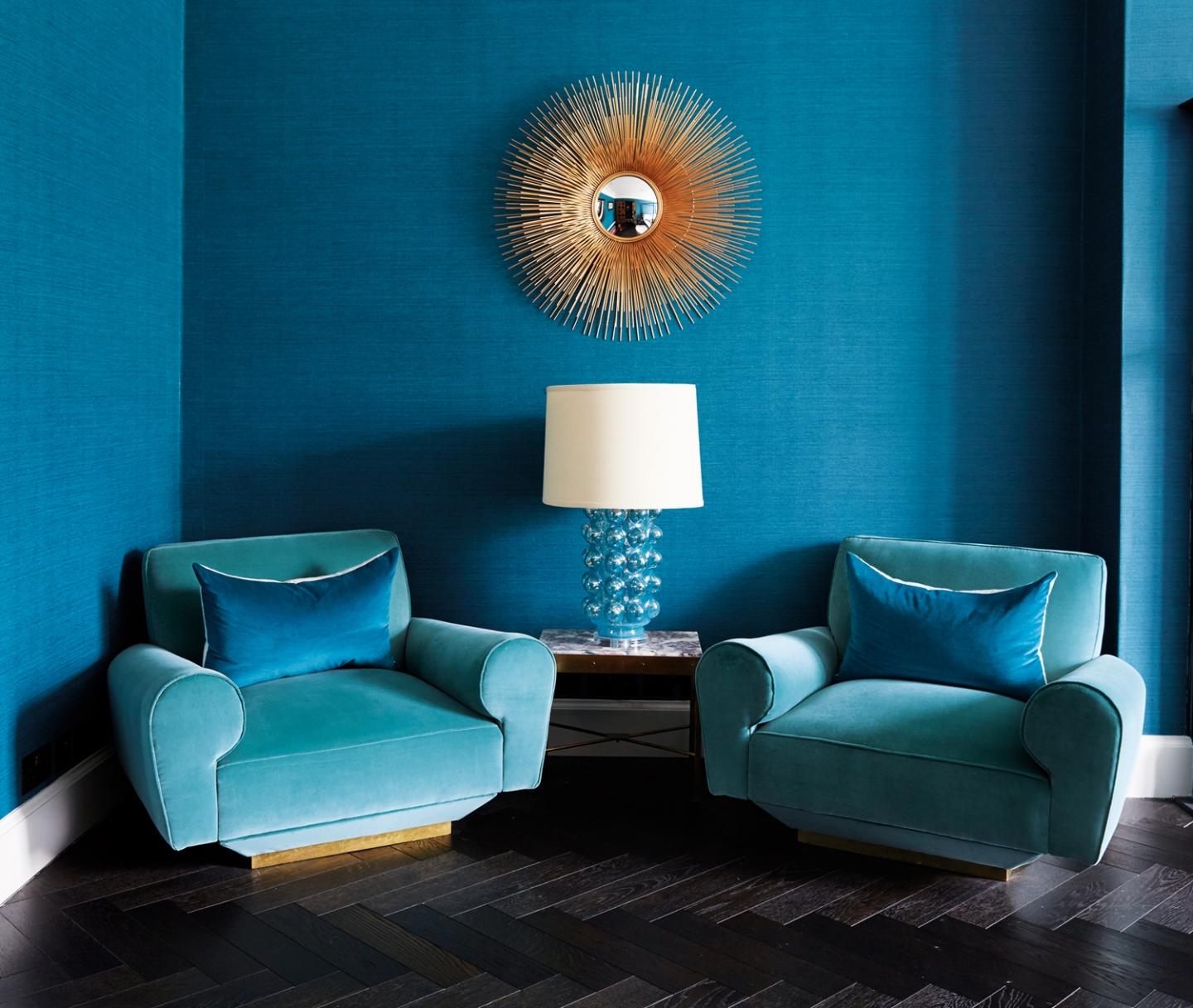 Shades of turquoise adorn a quaint reading area