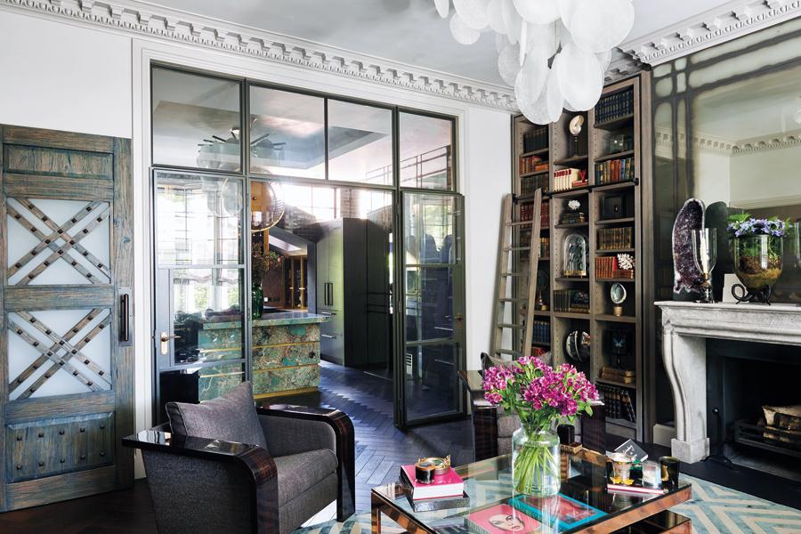 Custom-made bookshelves filled with antique leather- and cloth-bound books monogrammed with the client's name line the walls in the reception room