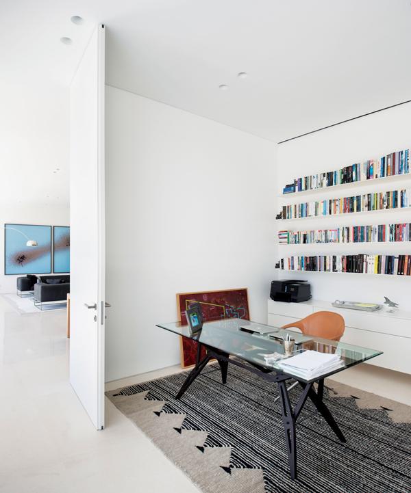 Pared back interiors adorn the library, which houses a careful collection of personal items