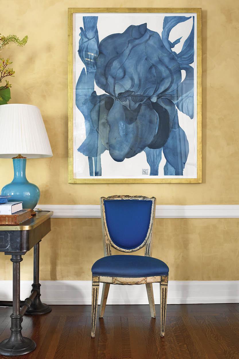 An 18th century chair in a rich blue upholstery pairs beautifully with an abstracted floral painting by Sarah Graham. “Imagine this homeowner’s surprise when he asked his wife what she wanted for Christmas and she answered: to have me decorate their newly purchased stone house on the East Coast.” (Photography by Francesco Langese)