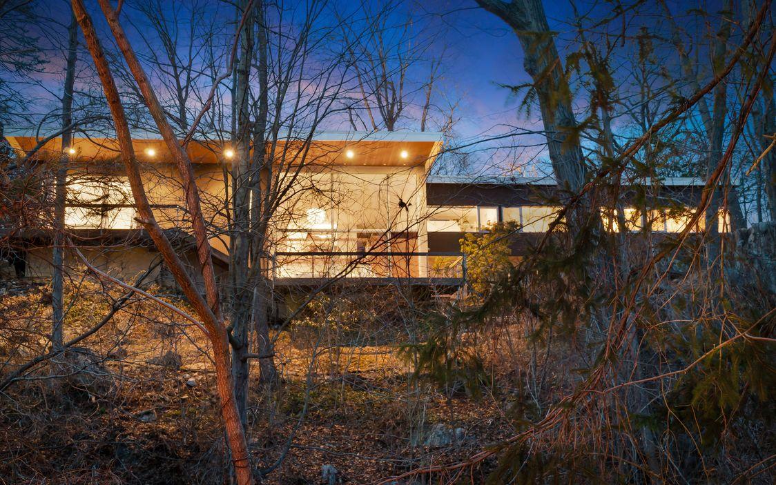 With its warm lighting, the striking property gives the impression of a treehouse at night