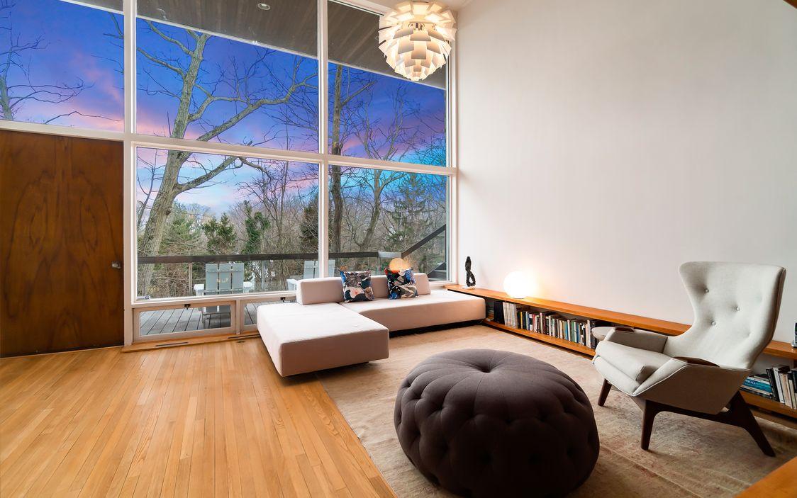 Floor to ceiling windows allow the living room to be bathed in natural light